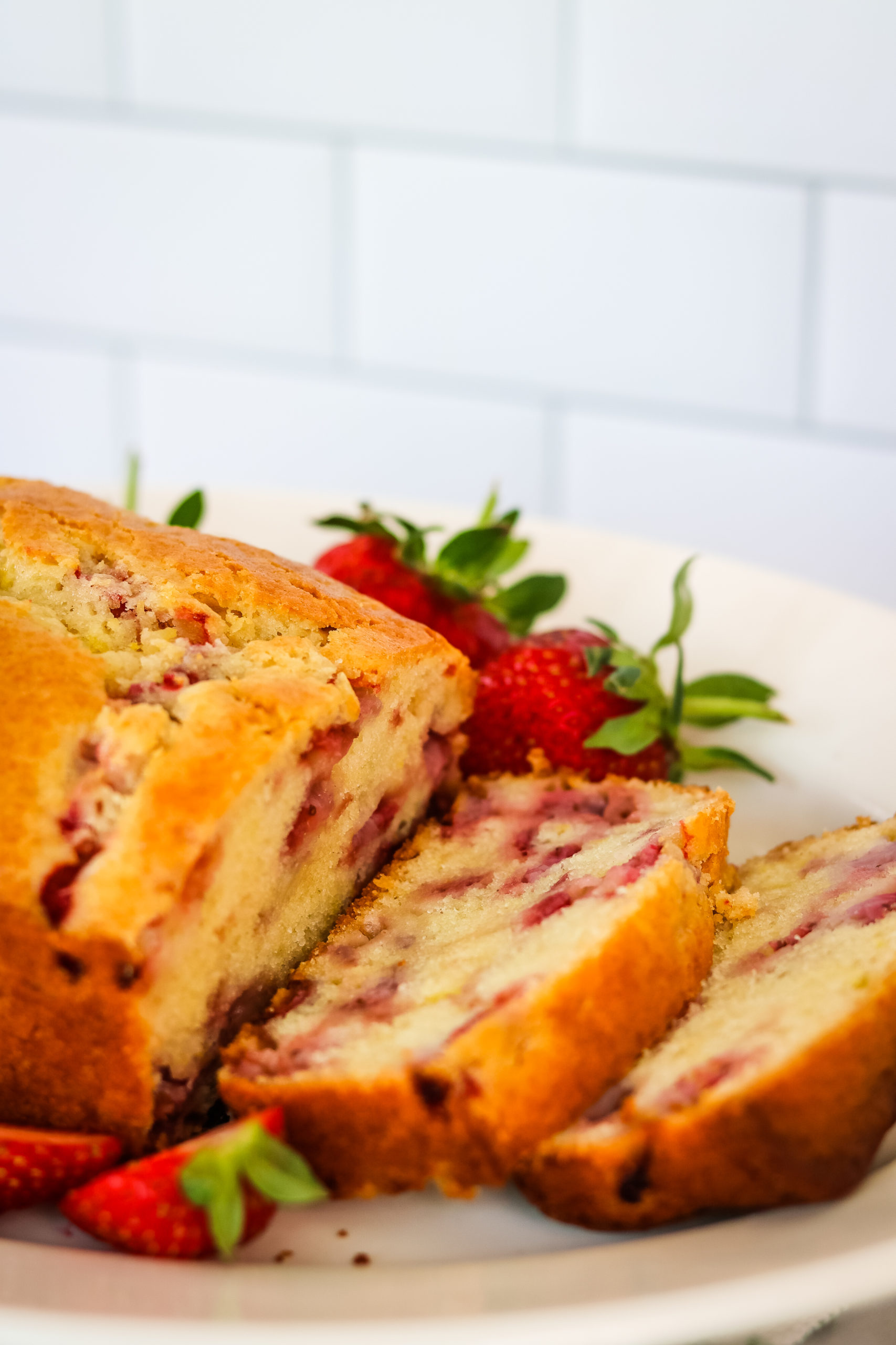 A loaf of Strawberry Bread with some slices.