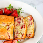 Closeup on the Strawberry Bread with strawberries on the side.