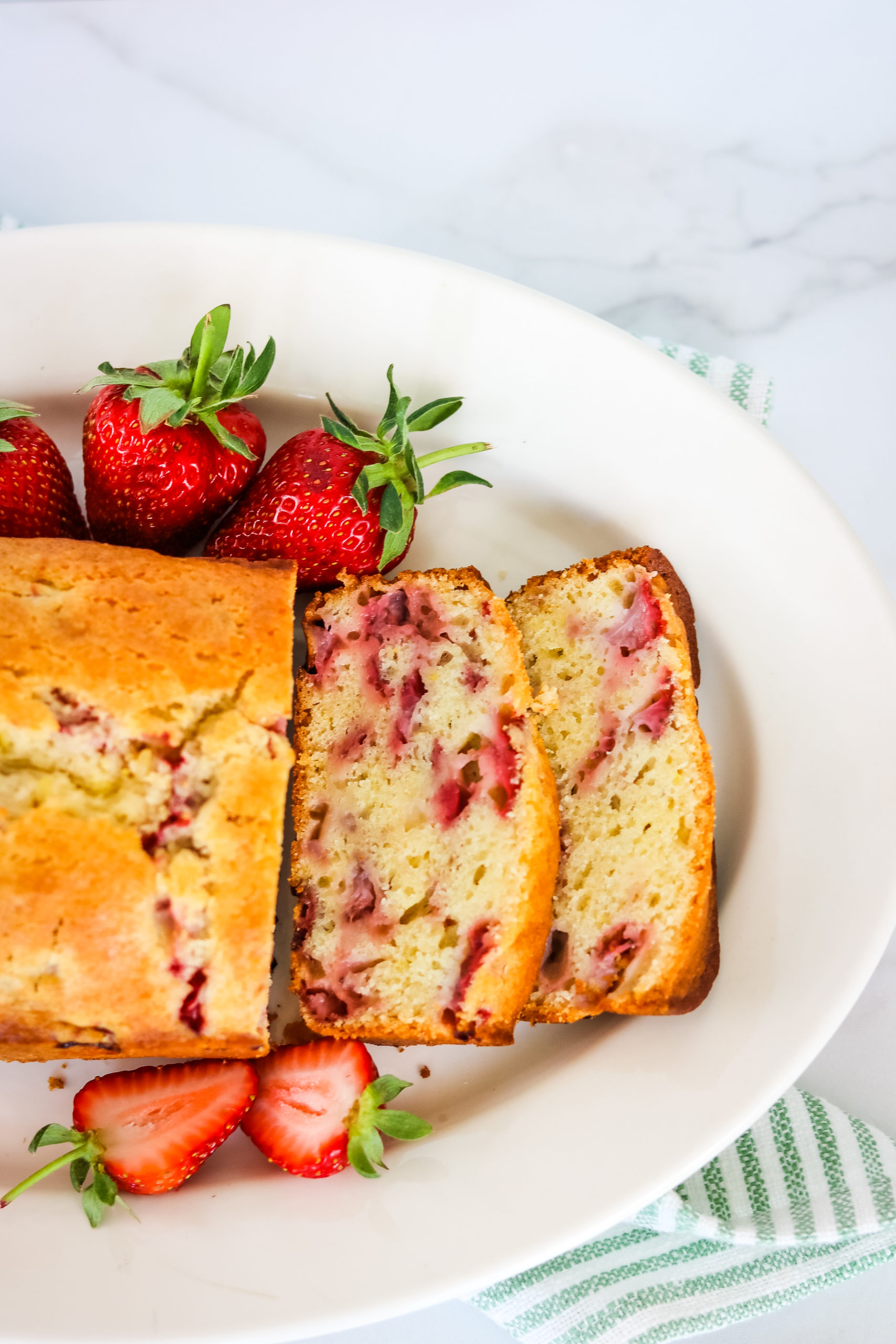 Closeup on the Strawberry Bread with strawberries on the side.