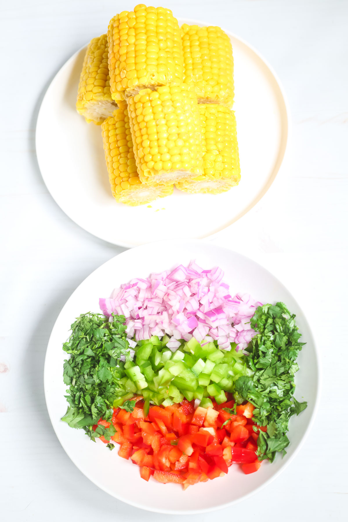 Grilled corn with chopped vegetables on a plate.