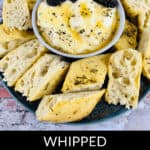 A delightful bowl of whipped ricotta dip, drizzled with honey and topped with juicy blackberries, sits surrounded by sliced bread.