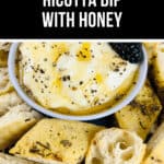 A bowl of luscious whipped ricotta dip with honey sits center stage, surrounded by slices of herb-topped bread.