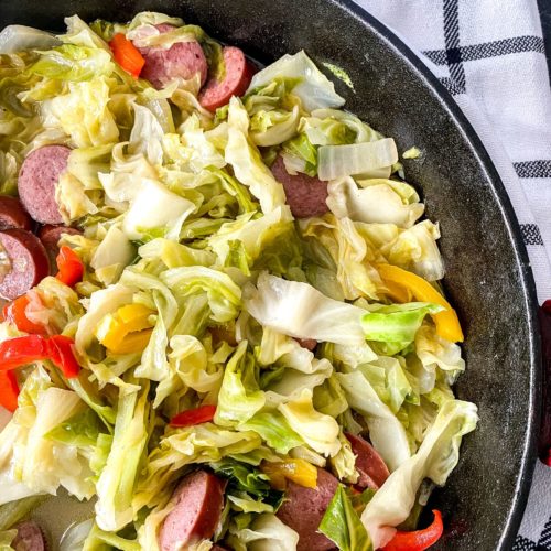 Sausage Fried Cabbage in a cast iron pan.