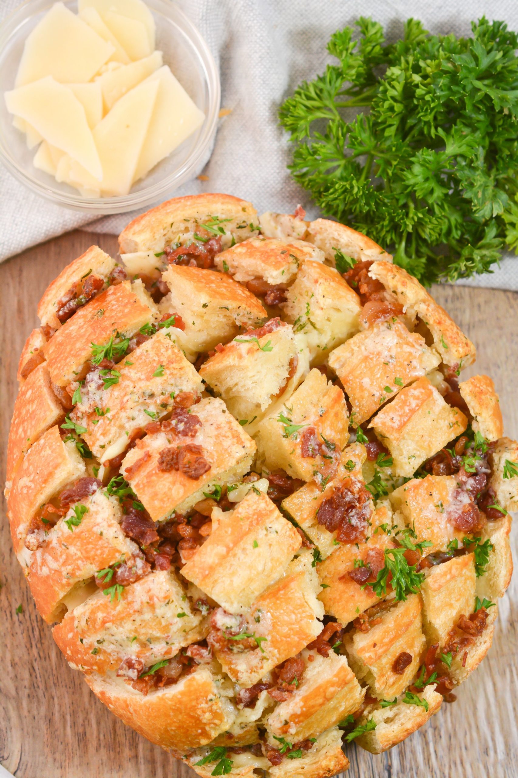 Bacon Ranch Crack Bread with a side of cheese and fresh herbs.