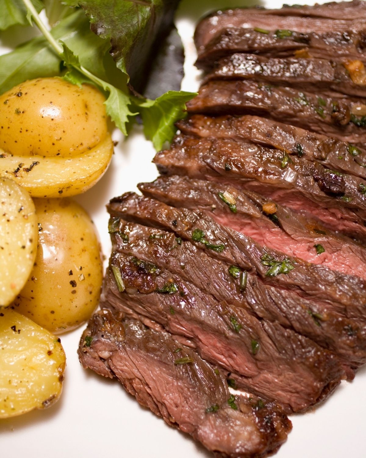 Skirt steak with side of potatoes.