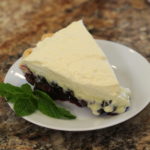 A white plate with Blueberry Cream Pie.