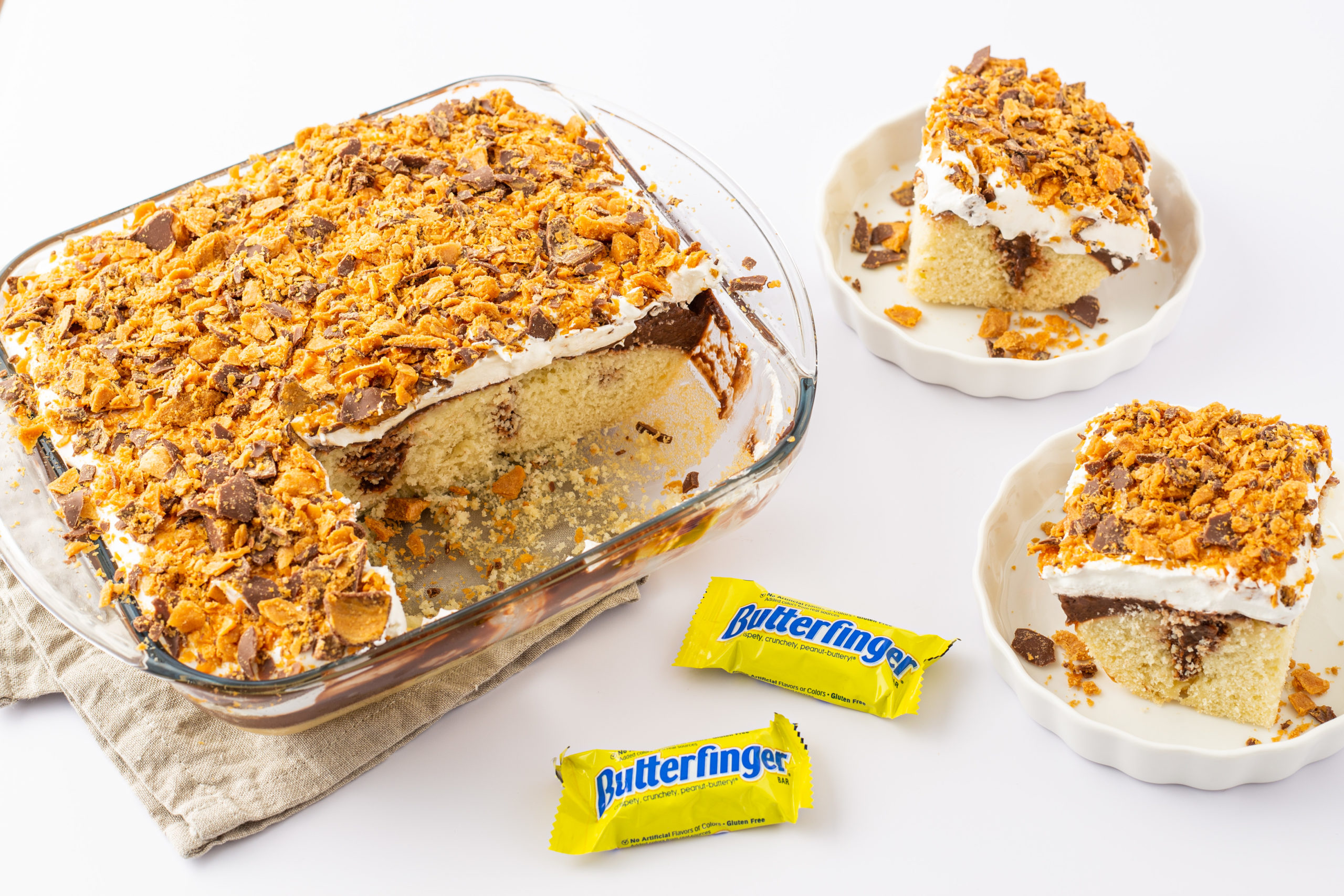 A slice of cake with some mini butterfingers.