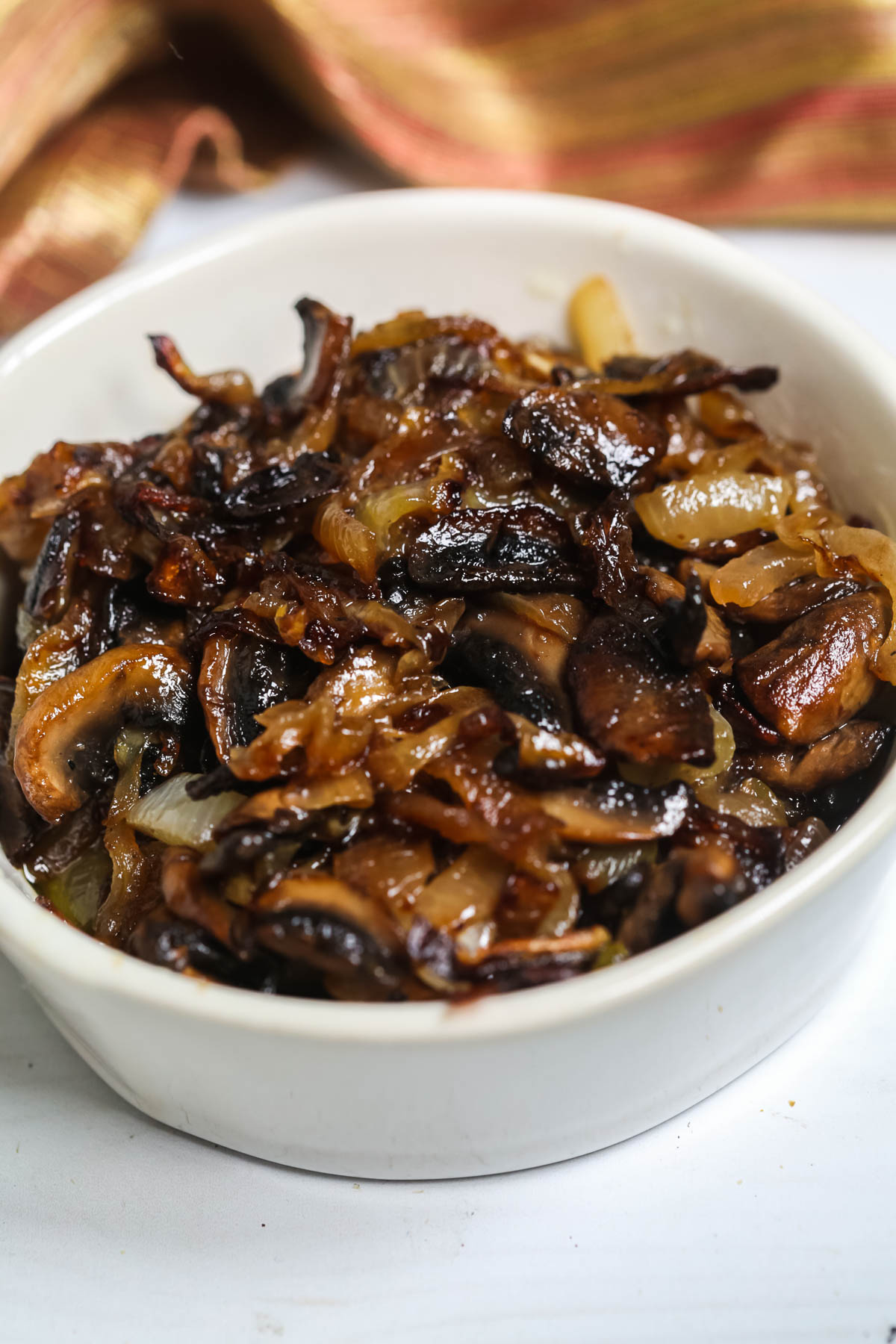 A white dish of the mushrooms and onions.