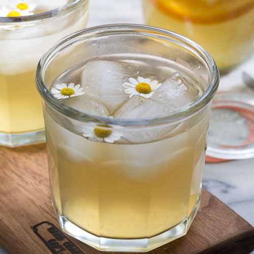 Chamomile and Honey Whiskey Cocktail garnished with flowers