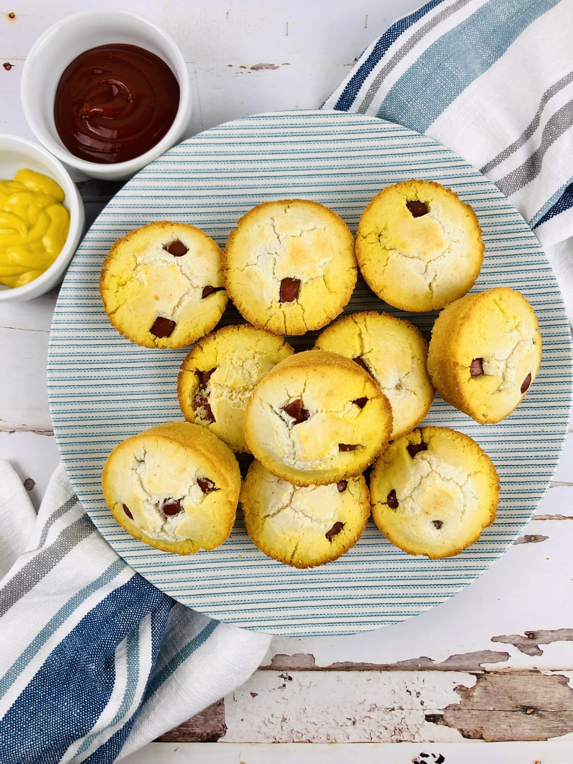 Corn Dog Muffins stacked on a plate.