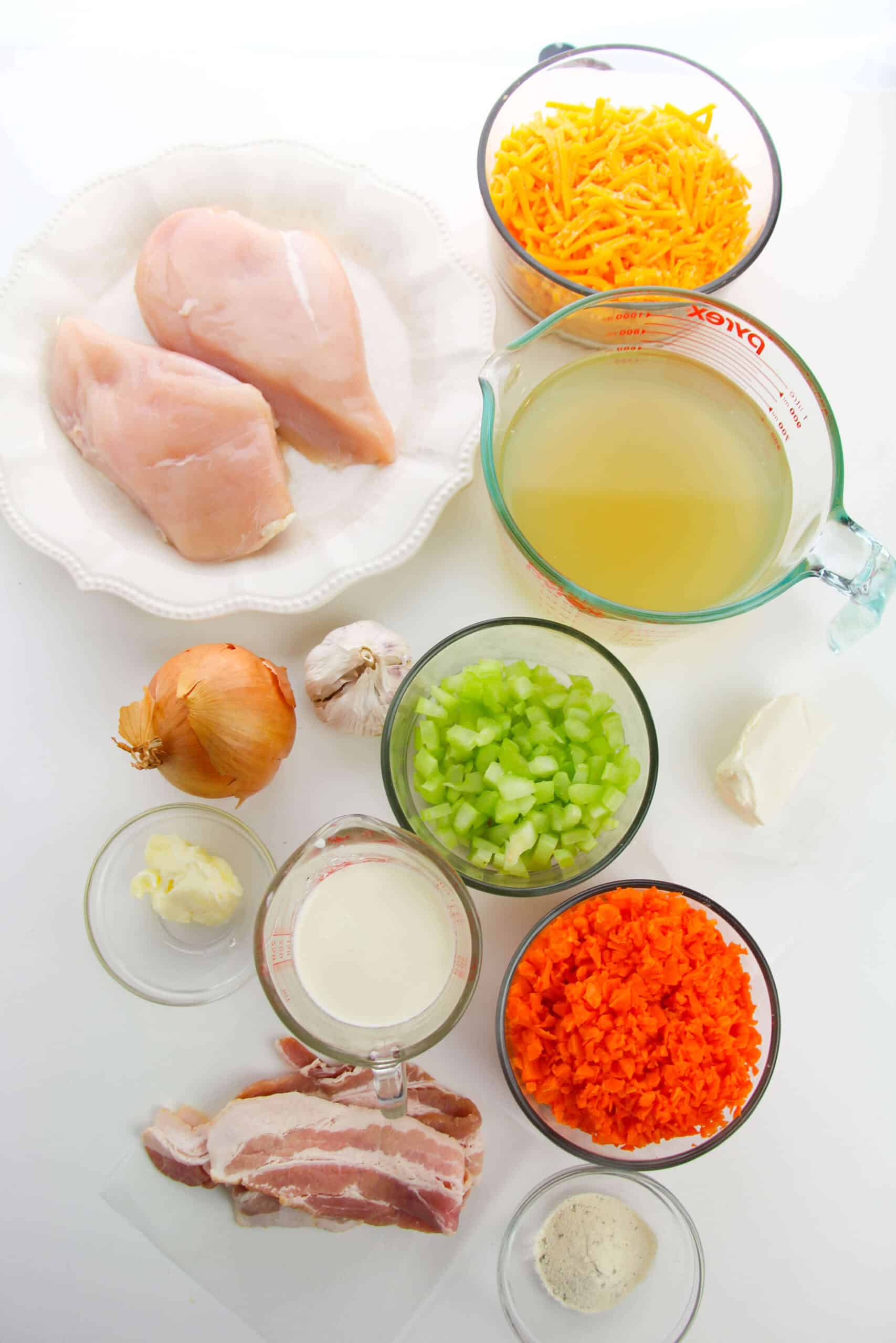 Discover the comforting flavors of Cracked Chicken Soup with ingredients like raw chicken breasts, shredded cheese, and savory chicken broth. Add fragrant onion, garlic, crispy bacon, and a splash of cream. Enhanced with cream cheese and butter for ultimate creamy indulgence.