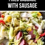 A skillet filled with cooked cabbage, sliced sausage, and colorful bell peppers with a text overlay reading "Easy Fried Cabbage and Sausage.