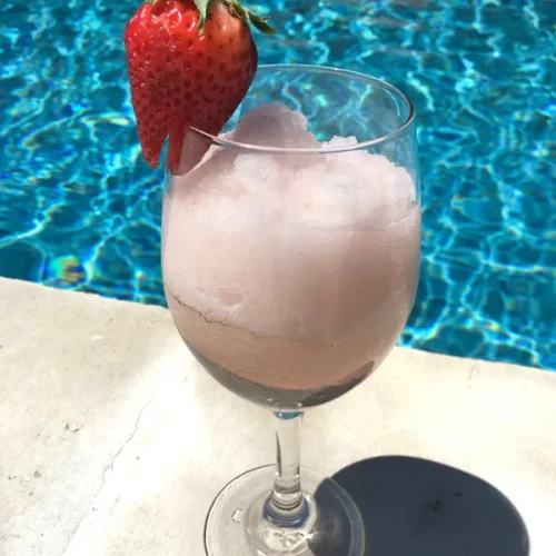 A Frose drink garnished with a strawaberry
