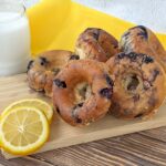 Glazed Blueberry Donuts with some lemon on the side.