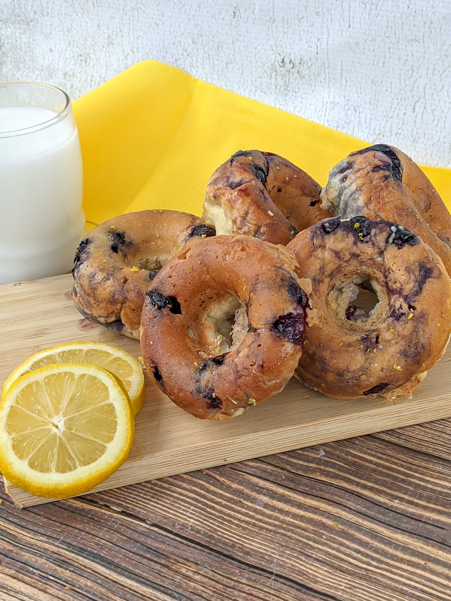 Glazed Blueberry Donuts with some lemon on the side.
