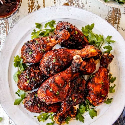 An overhead picture of several grilled chicken legs covered in BBQ sauce
