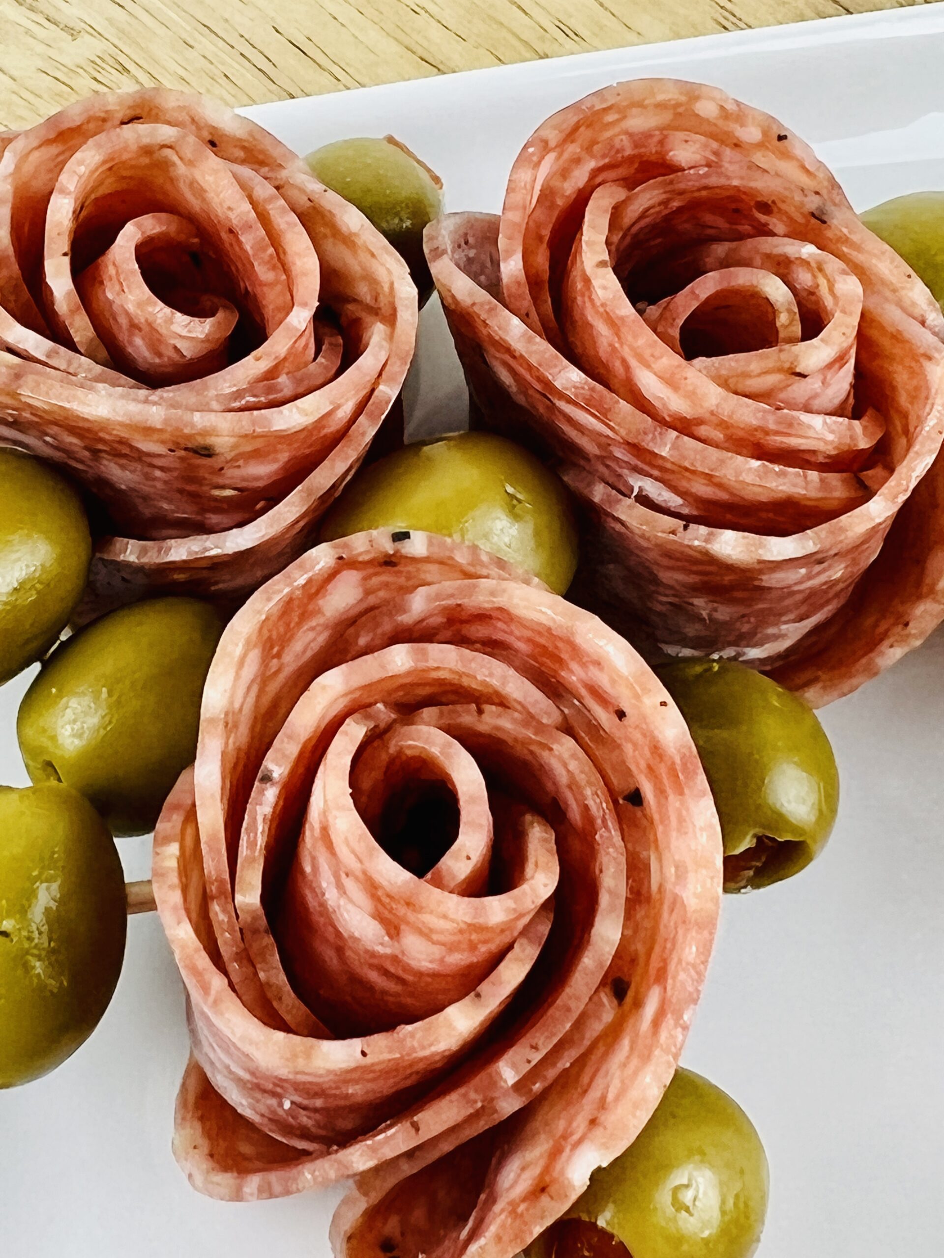 Top photo of three of the salami roses.