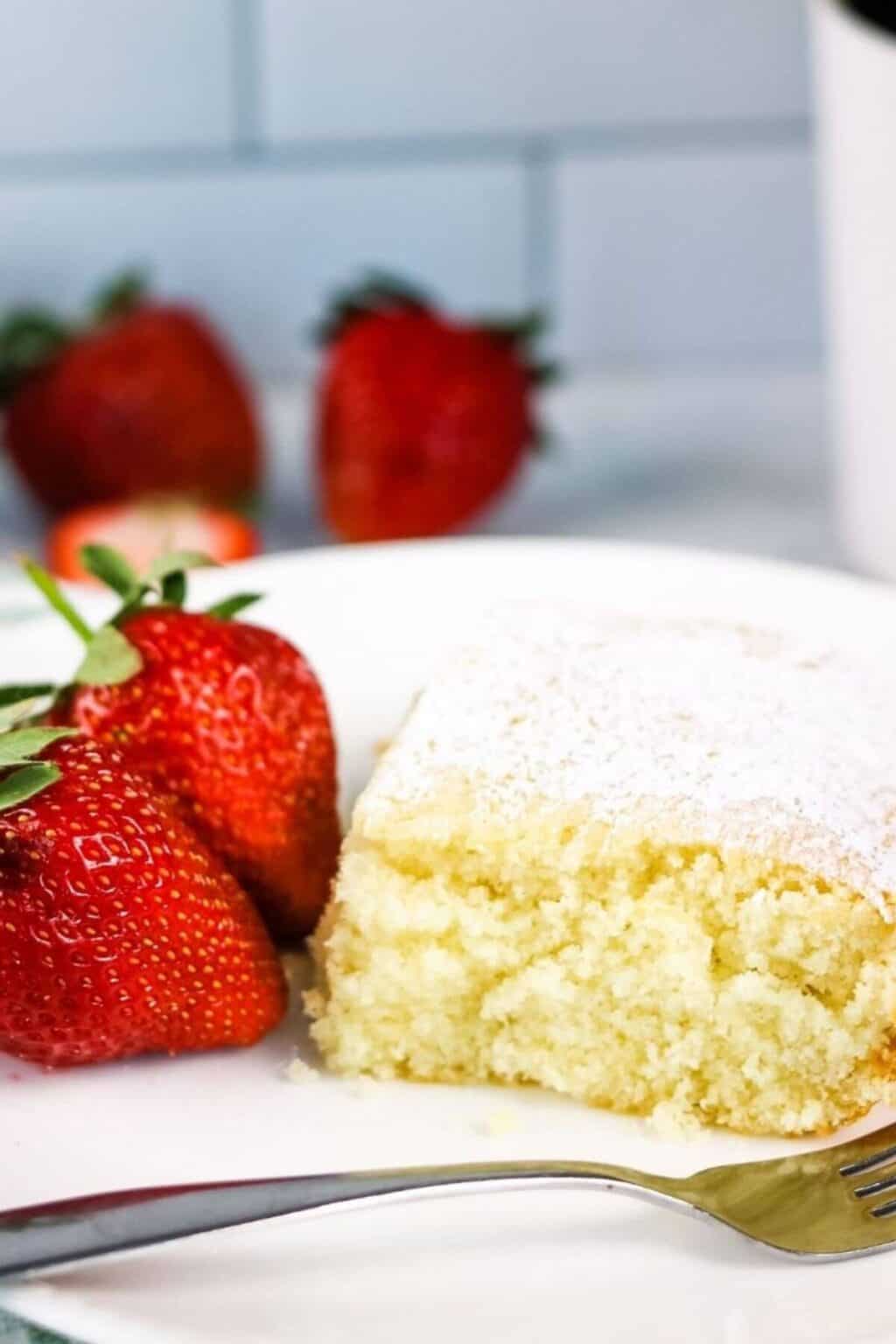 A piece of lazy cake with fresh strawberries on a white plate.
