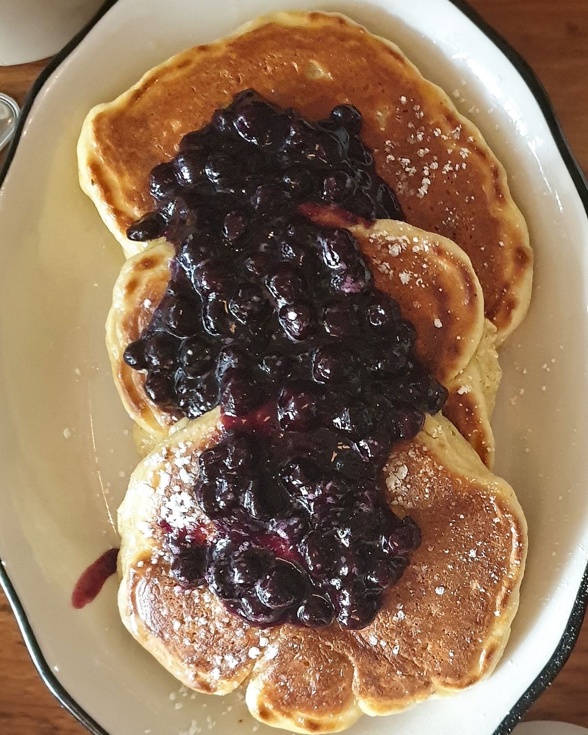 Top shot of lemon pancakes with a blueberry topping.
