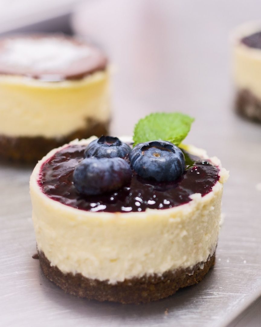Mini Blueberry Cheesecakes with a little mint leaf accent.