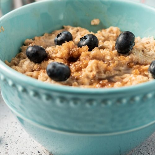 Oatmeal with Blueberries in an aqua bowl.