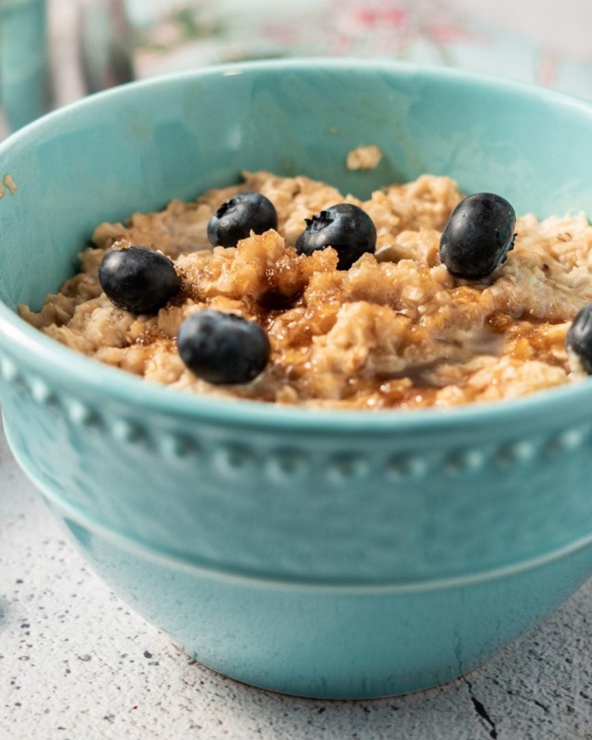 Oatmeal with Blueberries in an aqua bowl.