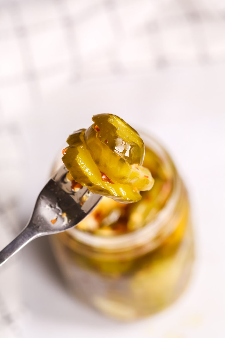 Sweet and Spicy Pickles on a fork.