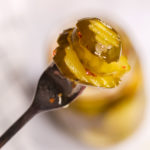 a closeup on a fork with Sweet and Spicy Pickles.