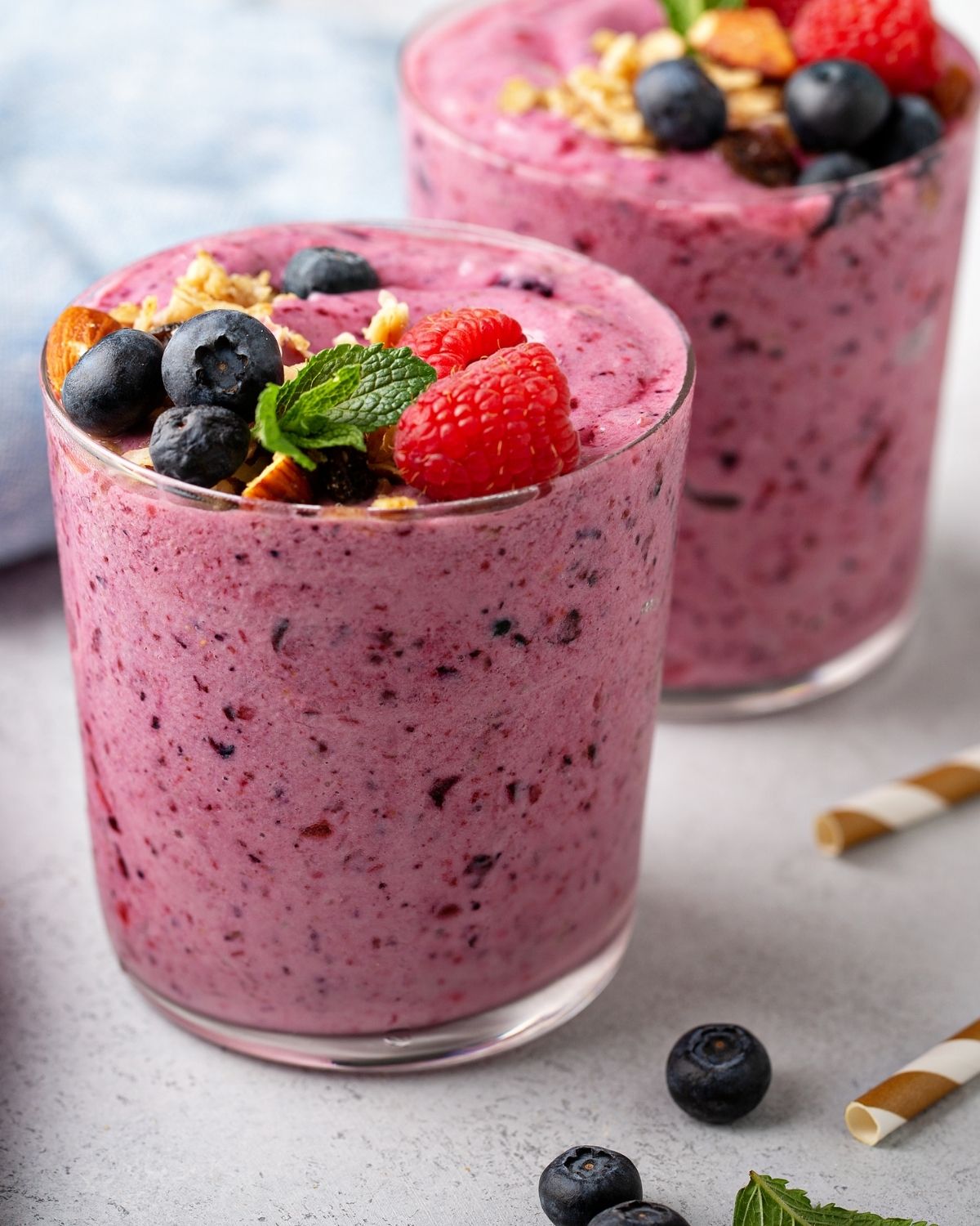 Triple Berry Smoothies with berries on top.