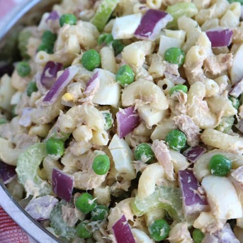 Closeup of pasta salad with tuna, peas, onion, and hard boiled egg