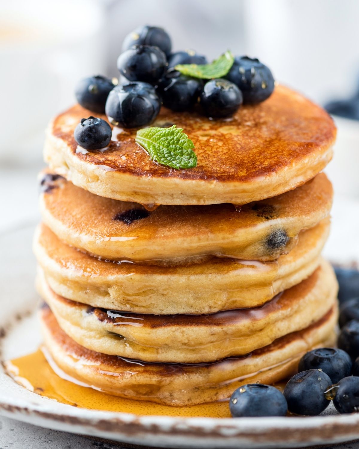 Whole Wheat Blueberry Pancakes stacked on a platter.