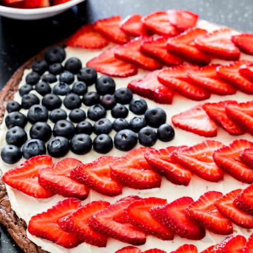 Brownie pizza with cream cheese frosting, strawberries and blueberries