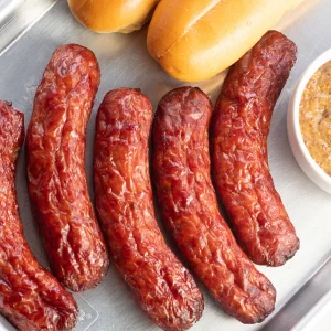 Five smoked sausaged on a metal platter