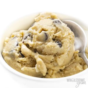 A bowl of yellowish ice cream with chocolate chips in it