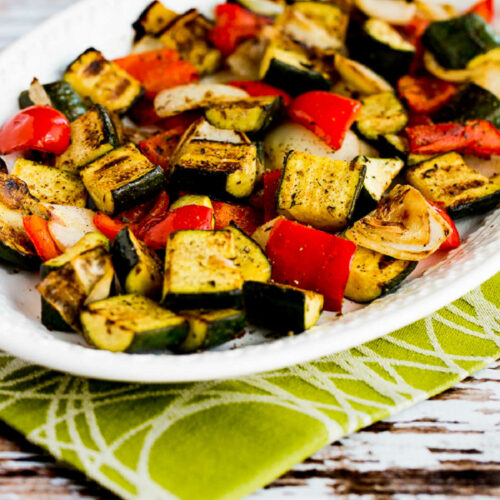 A plate of grilled vegetables with zucchini, peppers, and other vegetables