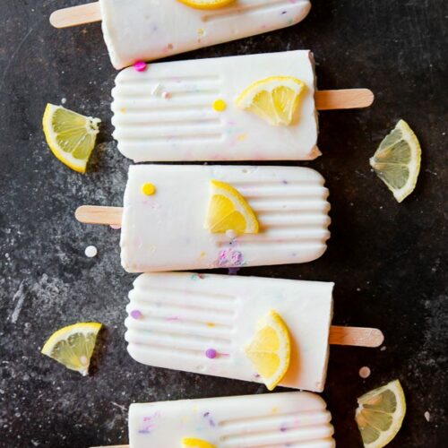 five 4 ingredient lemon popsicles next to one another on table