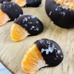 a group of the orange slices covered in chocolate.