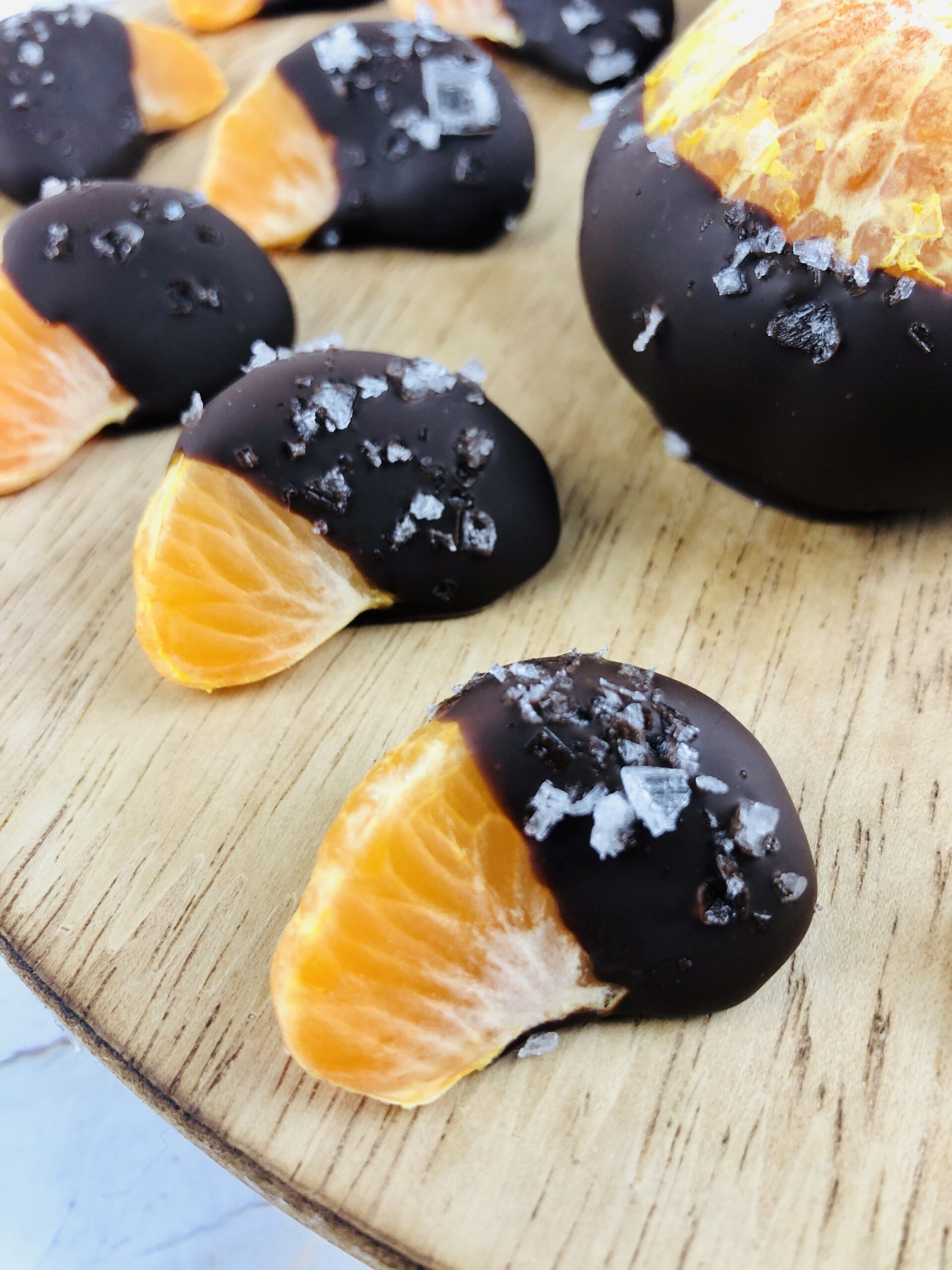 a group of the orange slices covered in chocolate.