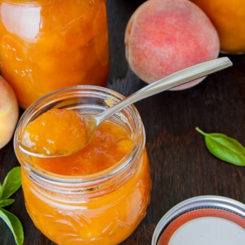 peach preserves on mason jar glass