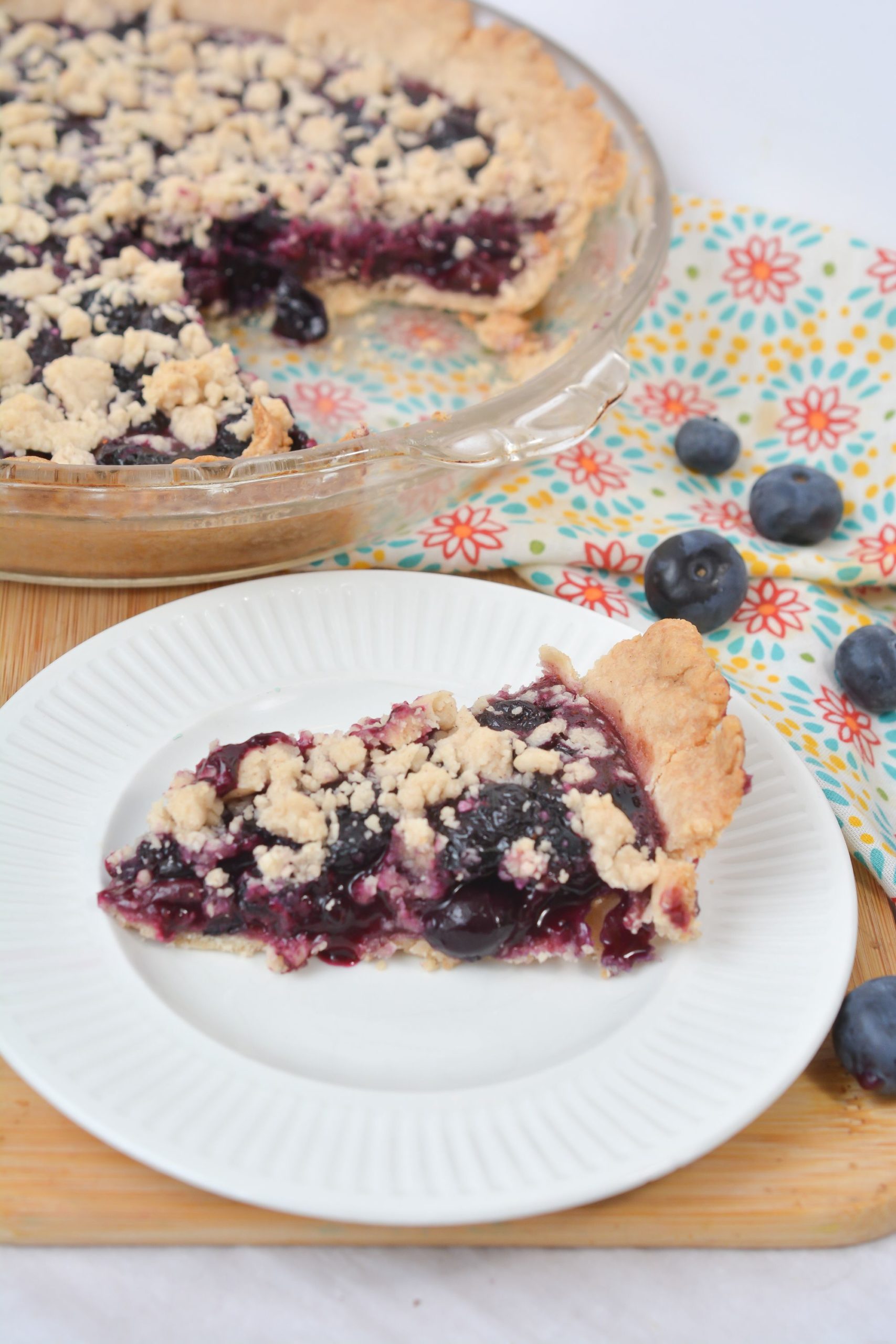 A side view of blueberry crumb pie.