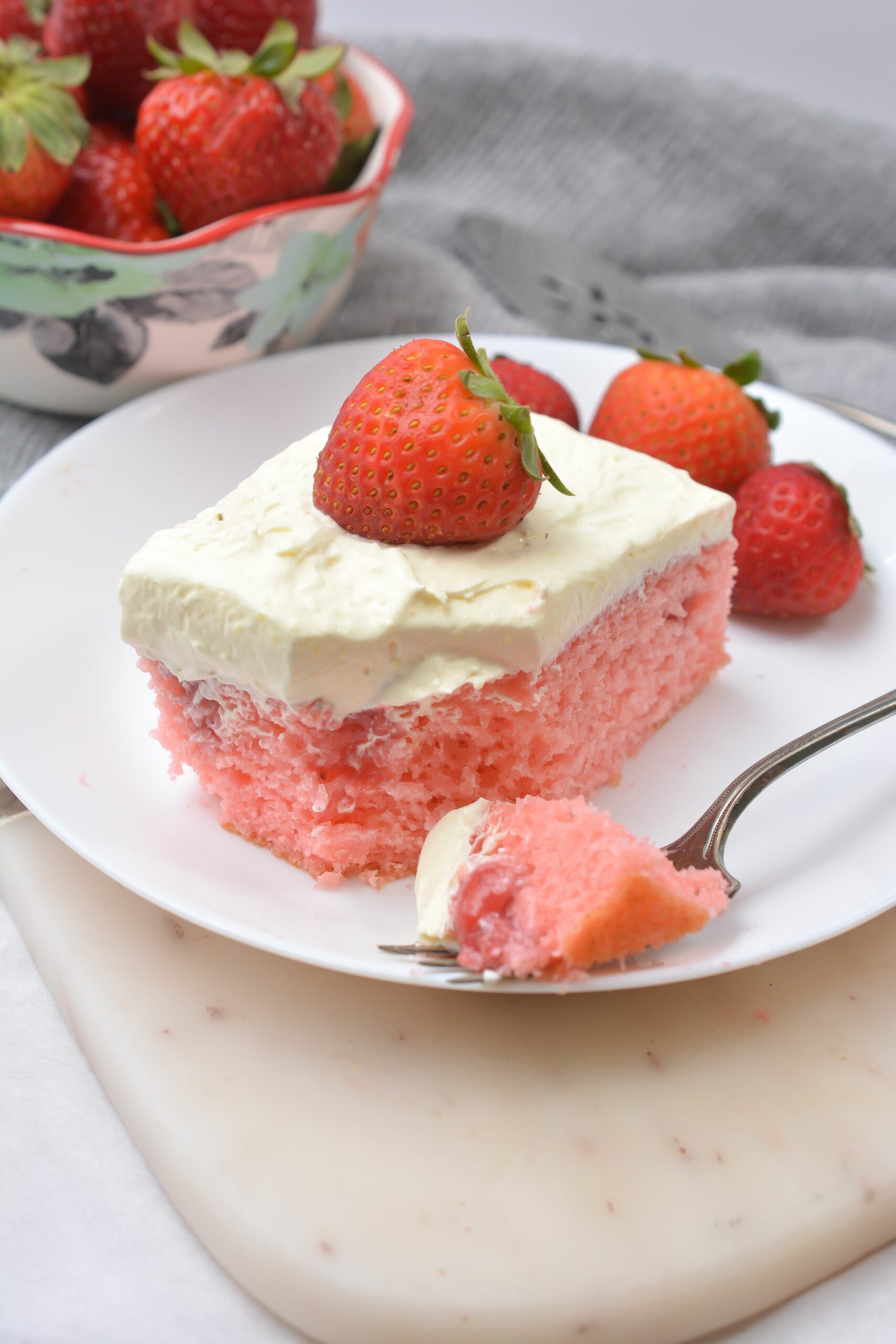 A fork of the Fresh Strawberry Poke Cake.