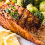 Grilled BBQ Salmon with a side of lemon and broccoli.