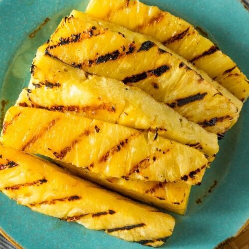 Grilled Pineapple Slices on a blue plate.