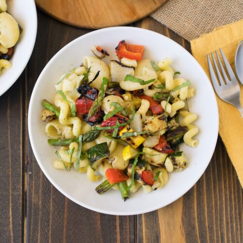 An overhead shot of pasta salad with fresh grilled vegetables