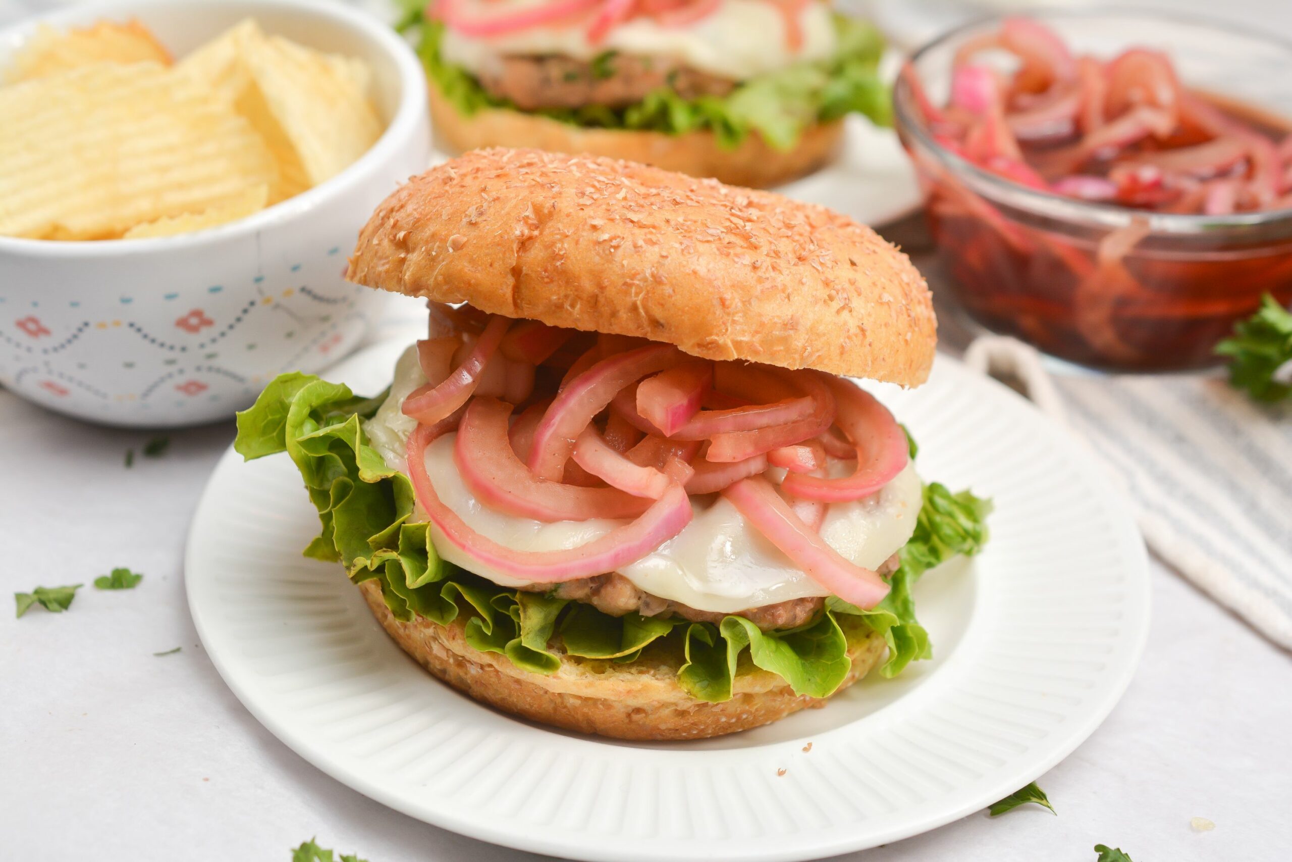 Grilled Turkey Burgers with Pickled Onions cheese and lettuce added.