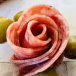 Slices with three green olives on a light-colored surface, perfect for anyone.