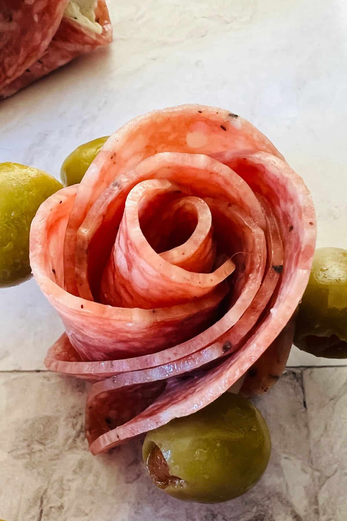 Slices with three green olives on a light-colored surface, perfect for anyone.