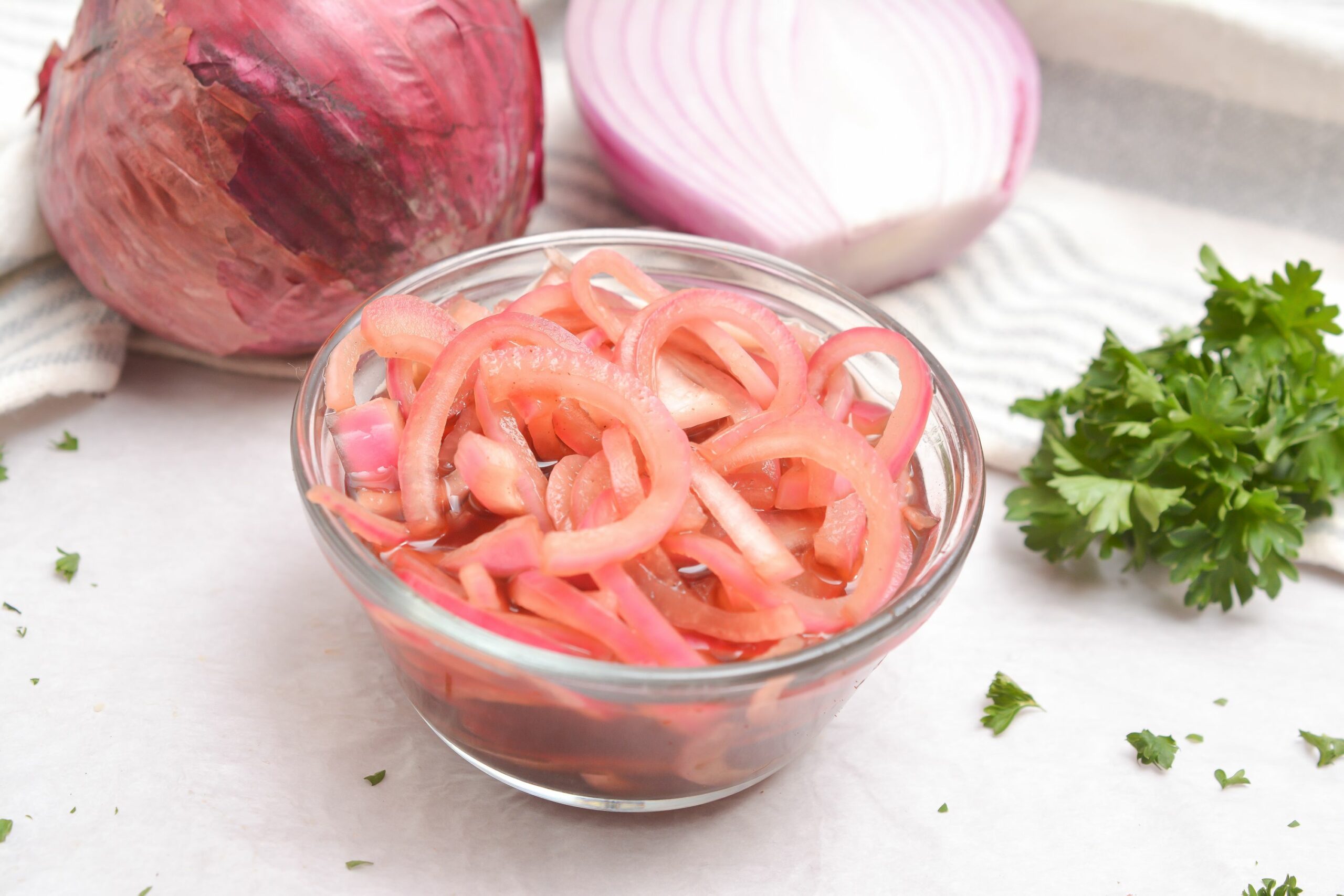 Picled onions with sides for a burger.