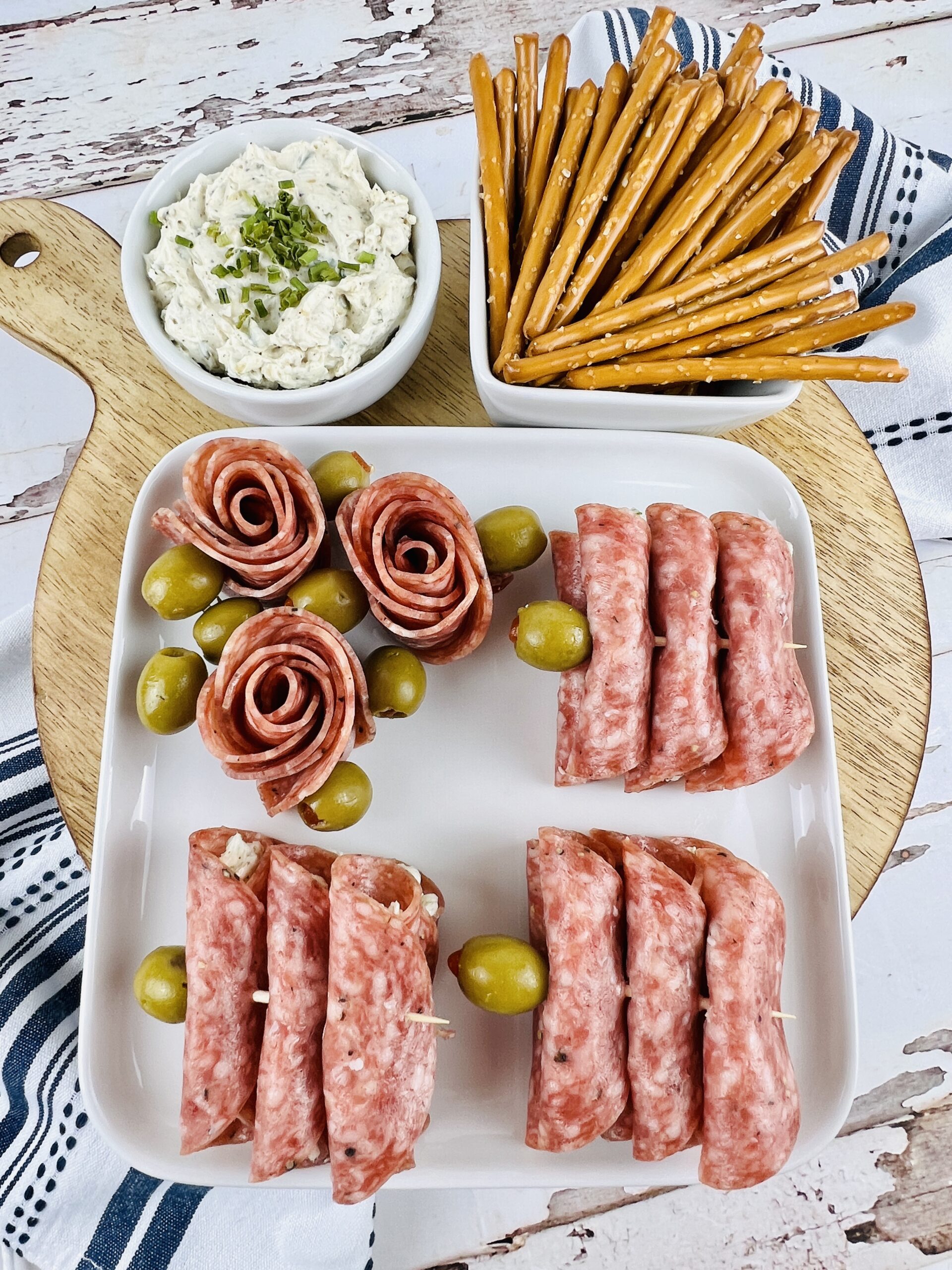 A plate full of the rollups with some salami roses.