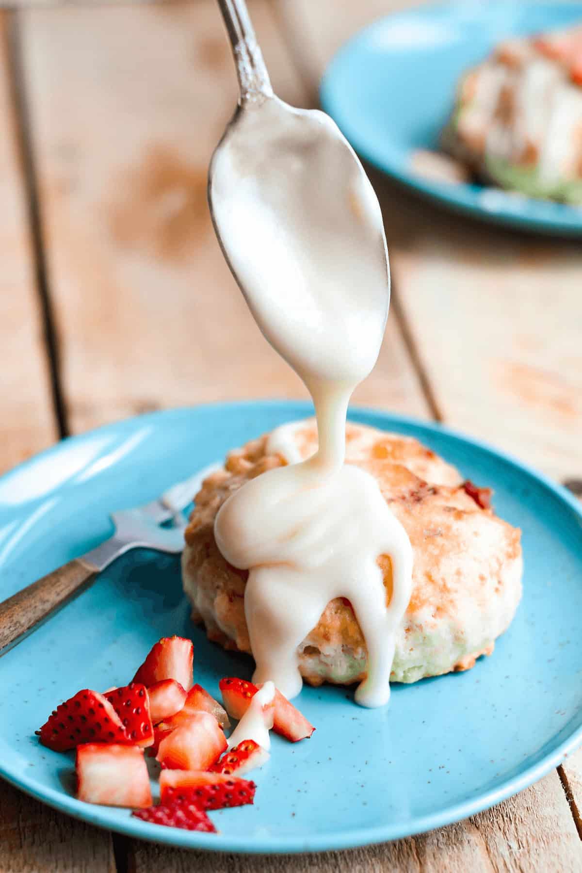 A drizzle of icing onto of the scone.